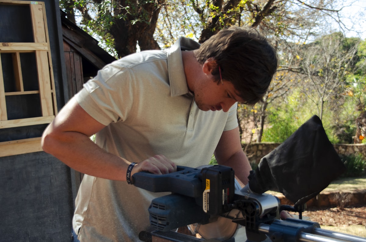 Craftsman hands working with a saw in a workshop